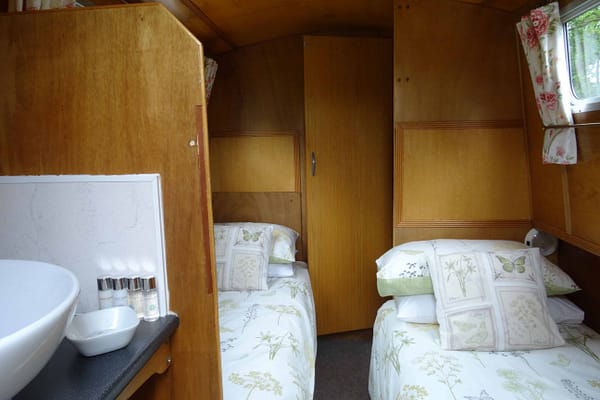 In the rear cabin there are two single beds and a wash area