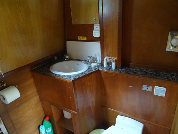 The bathroom contains a shower and electric flush toilet
